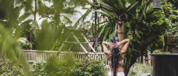 model taking a jungle shower